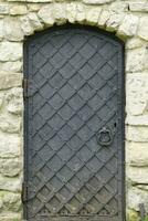 Old ancient metal door texture in european medieval style photo