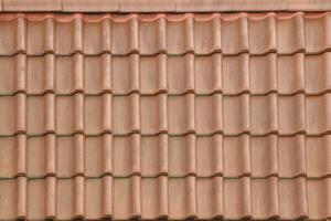 Architectural textured background of brown roof metal tile photo