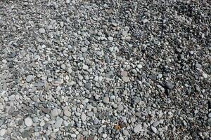 Texture of pebbles from the sea shore bank beach photo