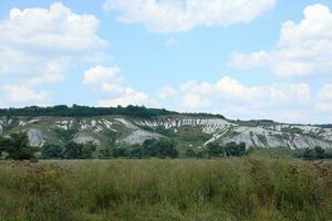 Ancient multimillion chalk mountains on the steppe surface of earth photo