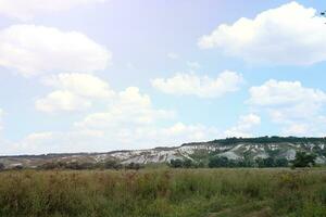 Ancient multimillion chalk mountains on the steppe surface of earth photo