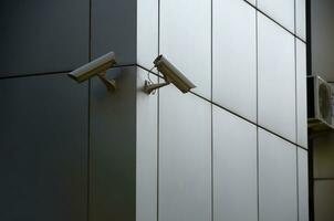 Modern CCTV cameras on a silver plastic wall photo