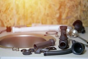 Tools and water tap ready for installation sink on countertop photo