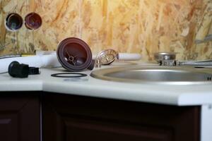 Tools and water tap ready for installation sink on countertop photo