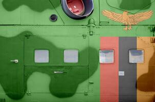 Zambia flag depicted on side part of military armored helicopter closeup. Army forces aircraft conceptual background photo