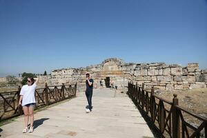 ANTALYA, TURKEY - MAY 15, 2021 Ruins of ancient city Hierapolis near Pamukkale, Turkey at sunny day. Parts of old historical buildings with big blocks photo