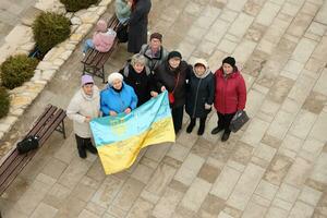 TERNOPIL, UKRAINE - APRIL 2, 2023 People with flag during mission in complex of Ukrainian Jerusalem in the Mari spiritual center of Zarvanytsia In the Terebovlya district of the Ternopil photo