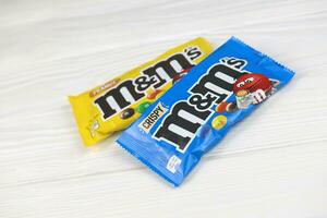 KHARKIV, UKRAINE - JANUARY 2, 2021 M and Ms colorful button shaped chocolate candies. Multi colored chocolates each of which has the letter m printed in lower case in white photo