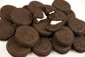 Oreo sandwich cookies on white table. Oreo is a sandwich cookie with a sweet cream is the best selling cookie in the US photo