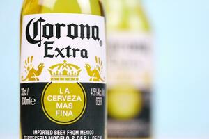 KHARKOV, UKRAINE - DECEMBER 9, 2020 Two Bottles of Corona Extra Beer. Corona produced by Grupo Modelo with Anheuser Busch InBev most popular imported beer in the US photo