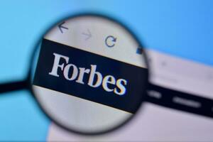 Homepage of forbes website on the display of PC, url - forbes.com. photo