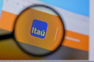 Homepage of itau website on the display of PC, url - itau.com. photo