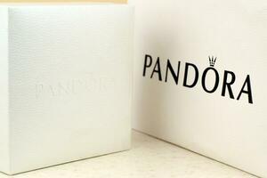 Pandora carrier paper bag with logo. Pandora brand is a manufacturer of jewelry products in Copenhagen, Denmark photo