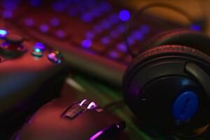 Gamesir g3s video game controller and Bloody p93 gaming mouse on office table with a4tech keyboard and headphones photo