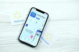 KHARKOV, UKRAINE - MARCH 5, 2021 Walmart icon and application from App store on iPhone 12 pro display screen on white table photo
