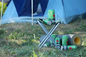 KHARKOV, UKRAINE - JULY 31, 2021 Green tin cans of Heineken lager beer produced by the Dutch brewing company Heineken N.V. photo