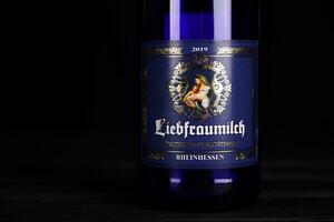 KHARKOV, UKRAINE - DECEMBER 3, 2020 St.Ursula Liebfraumilch Rheinhessen wine bottle on dark black background. Elite alcohol photo