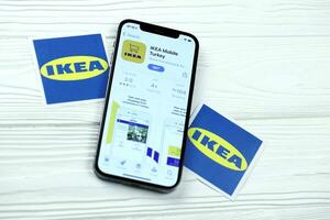 KHARKOV, UKRAINE - MARCH 5, 2021 Ikea icon and application from App store on iPhone 12 pro display screen on white table photo