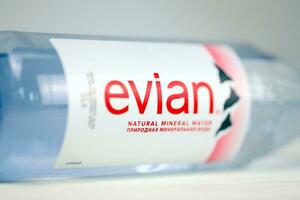 KHARKOV, UKRAINE - JULY 2, 2021 Bottle Of Evian Natural Mineral Water. Evian bottling factory located in Amphion, France photo