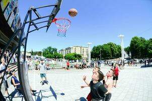 KHARKIV, UKRAINE - 27 MAY, 2018 Sports teams play streetball in the open air during the annual festival of street cultures photo