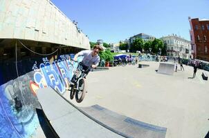 KHARKIV, UKRAINE - 27 MAY, 2018 Freestyle BMX riders in a skatepark during the annual festival of street cultures photo