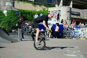 kharkiv, ucrania - 27 de mayo de 2018 ciclistas de bmx freestyle en un skatepark durante el festival anual de culturas callejeras foto