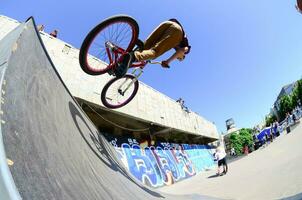 KHARKIV, UKRAINE - 27 MAY, 2018 Freestyle BMX riders in a skatepark during the annual festival of street cultures photo