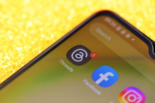 KYIV, UKRAINE - JULY 7, 2023 Threads by Meta application on display of Samsung smartphone lying on table photo