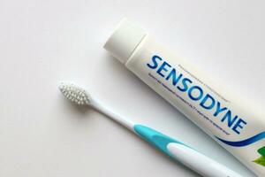 KYIV, UKRAINE - MAY 4, 2022 Sensodyne fluorine or fluor is a daily fluoride toothpaste photo