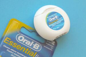 KYIV, UKRAINE - JULY 7, 2023 Oral-B Essentail Floss. Waxed dental floss in round case photo