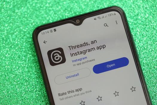 KYIV, UKRAINE - JULY 7, 2023 Threads by Meta application on display of Samsung smartphone lying on table photo