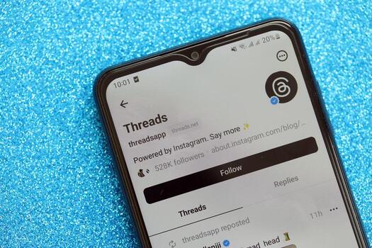 KYIV, UKRAINE - JULY 7, 2023 Threads by Meta application on display of Samsung smartphone lying on table photo