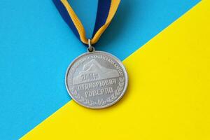 KYIV, UKRAINE - MAY 4, 2022 Medal for the person who conquered Mount Hoverla photo