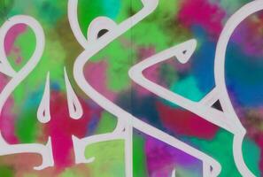 Colorful background of graffiti painting artwork with bright aerosol strips on metal wall photo