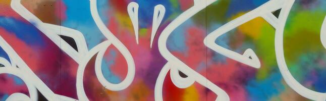 Colorful background of graffiti painting artwork with bright aerosol strips on metal wall photo