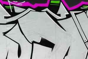 Colorful background of graffiti painting artwork with bright aerosol strips on metal wall photo