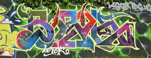 Colorful background of graffiti painting artwork with bright aerosol strips on metal wall photo