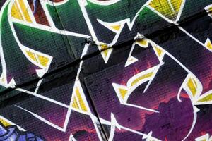 Colorful background of graffiti painting artwork with bright aerosol strips on metal wall photo