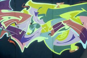 Colorful background of graffiti painting artwork with bright aerosol strips on metal wall photo