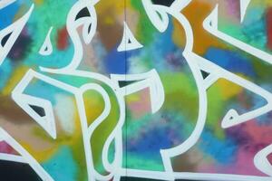 Colorful background of graffiti painting artwork with bright aerosol strips on metal wall photo