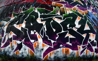 Colorful background of graffiti painting artwork with bright aerosol strips on metal wall photo