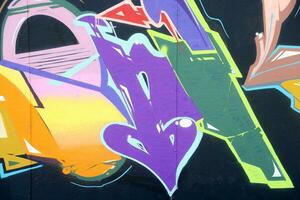 Colorful background of graffiti painting artwork with bright aerosol strips on metal wall photo