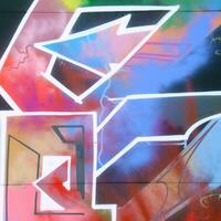 Colorful background of graffiti painting artwork with bright aerosol strips on metal wall photo