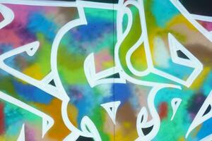 Colorful background of graffiti painting artwork with bright aerosol strips on metal wall photo