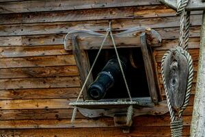 black cannon in the side of a wooden vintage warship background photo