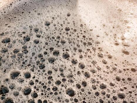 The process of making homemade grape wine. The operation of a hydraulic press to obtain grape juice for fermentation. Close-up of freshly squeezed grape juice photo