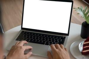 man using and typing on laptop computer mockup with blank screen. photo