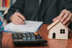 businessman working accountant document graph and chart on desk using calculator for calculate finance report in office. photo