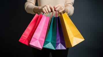 Cropped shot of female hand holding bunch of different colorful blank shopping bags over isolated black background. Many packets with in womans arms. Black friday sale concept. AI Generative photo
