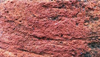 brick wall of red color, Old, beginning to collapse, carelessly laid brickwork, Background. Vintage brick old brickwork Texture. Carelessly made brickwork. Excess cement, broken brick. pattern texture photo